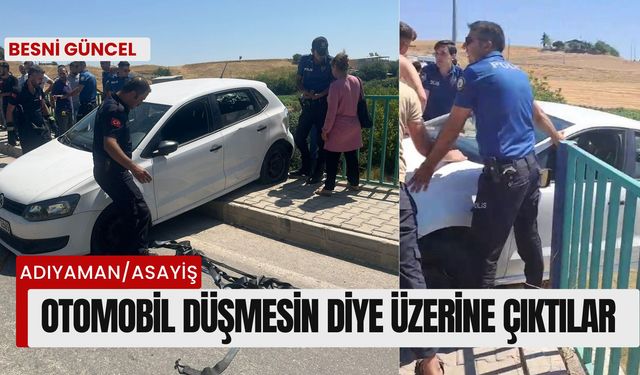 Köprüde asılı kalan otomobil düşmesin diye üzerine çıktılar